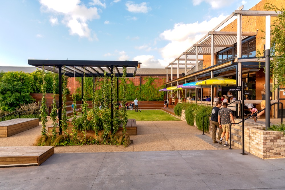 The open-air Hospitality Courtyard, lined with umbrellas and outdoor dining