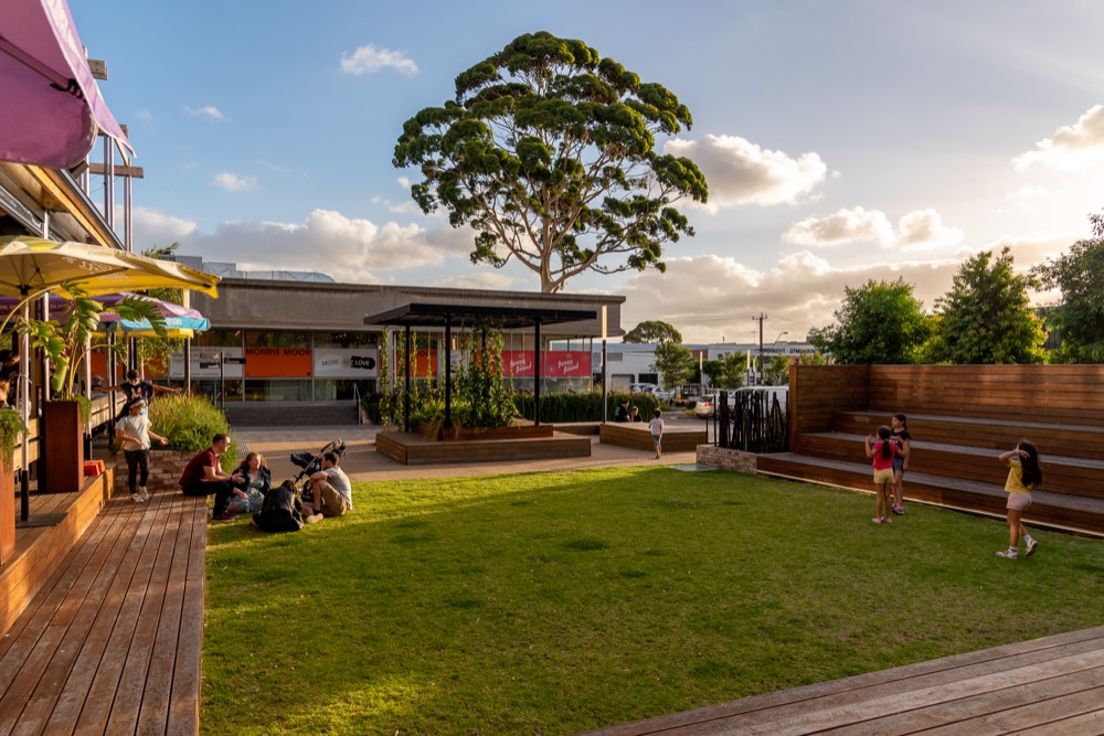 Families relaxing on the lawn at Morris Moor's Pocket Park